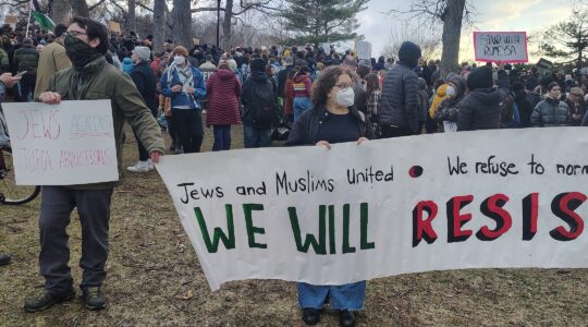 Jews at a rally holding signs reading "Jews and Muslims United" and "Jews Against Illegal Abductions"